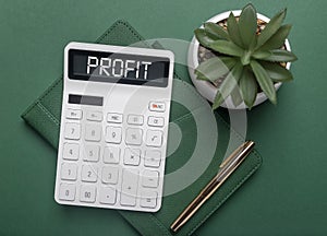Profit word inscription on calculator on green desk