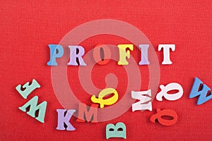 PROFIT word on red background composed from colorful abc alphabet block wooden letters, copy space for ad text. Learning english