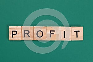 Profit word from wooden letters on green background