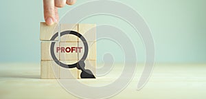 Profitability concept. Business profit results sales, margin, cost management. Hand placed wooden cubes with \