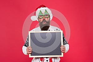 Profitable offer here. Rental services. Winter price drop. Bearded hipster Santa claus. Joyful man show blackboard copy