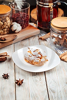 Profiterole sprinkled with powdered sugar photo