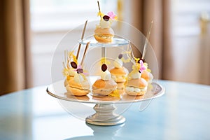 profiteroles arranged in pyramid shape on cake stand