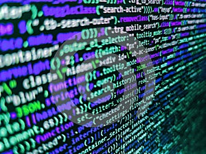 Program development concept. Programming code abstract screen of software developer. Closeup of Java Script and HTML code.