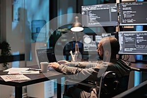 Programer compiling coding language on laptop