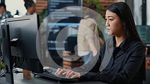 Programer writing algorithm focused on compiling source code sitting at desk