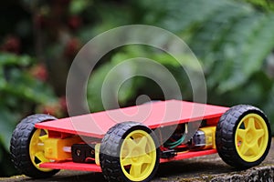 Programmable four wheels drive or 4WD robotic car with chasis. Hobby electronics project