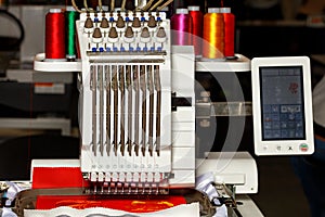 Programmable multicolored thread embroidery machine at work. Close-up. Copy space