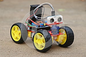 Programmable robotic car built using micro controller and ultrasonic distance sensor along with servos and dc motor. Working