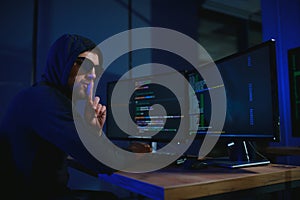 Programmer or computer hacker typing code