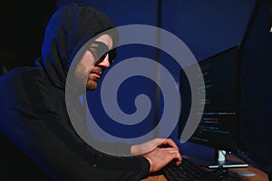 Programmer or computer hacker typing code
