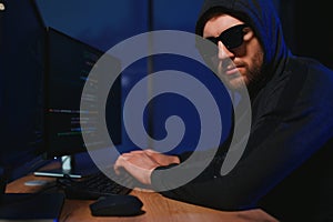 Programmer or computer hacker typing code
