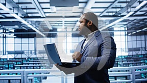 IT professional in server room looking for network issues