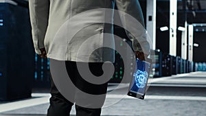 Programmer in data center using artificial intelligence tech on tablet
