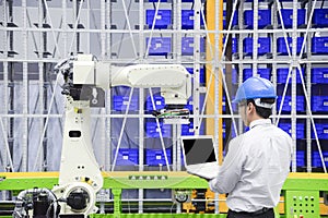 The programmer engineer control the robot for logistic warehouse