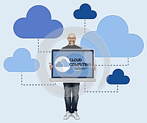 Programmer holding a laptop with cloud computing