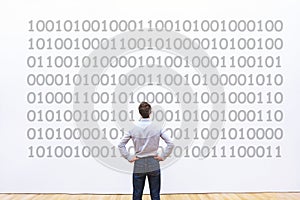 Programmer looking at binary code, coding concept, data encryption