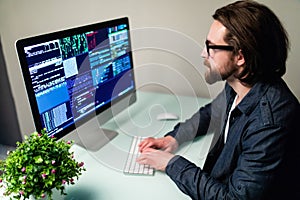 Programmer profession man writing programming code on laptop computer