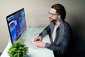 Programmer profession man writing programming code on laptop computer
