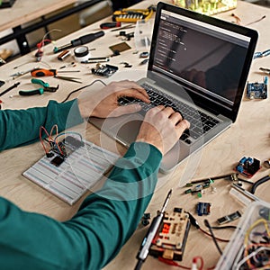 Programmer programming code of microchip in office
