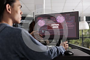 It programmer reading system error message on computer monitor