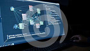 Programmer's Hand Coding Machine Learning Algorithm on Computer Screen in Dark Environment