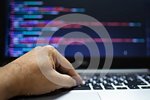 The programmer`s hand is writing the source code. Programmers write programs for use with internet business services. The