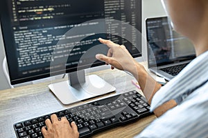 Programmer Team of  Developing programming and website working in a software develop company office, writing codes and typing data