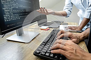 Programmer Team of  Developing programming and website working in a software develop company office, writing codes and typing data