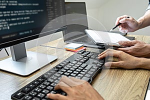 Programmer Team of  Developing programming and website working in a software develop company office, writing codes and typing data