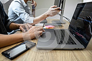 Programmer Team of  Developing programming and website working in a software develop company office, writing codes and typing data