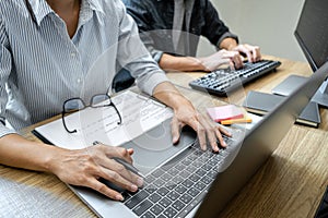 Programmer Team of  Developing programming and website working in a software develop company office, writing codes and typing data