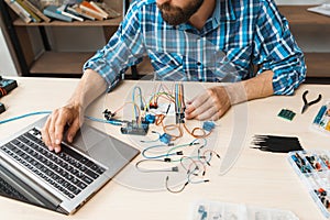 Programmer testing his new invention on laptop