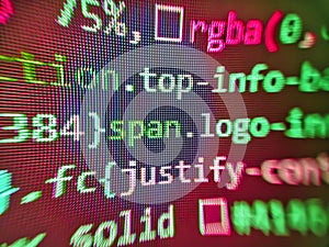 Programmer typing new lines of HTML code. Computer program. Abstract program code on computer screen. Technology background.