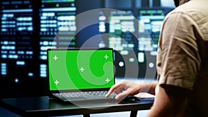 Programmer using green screen laptop