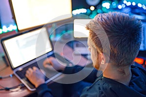 Programmer using laptop and PC, information coding