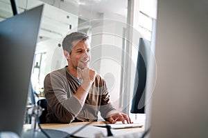 Programmer, web developer, designer working at office comparing mobile and desktop website versions