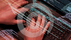 Programmer at work - software code running on screen and