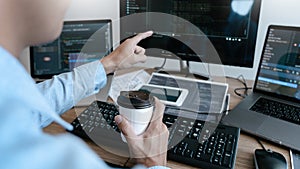 Programmer working On Computer In IT Office Typing Data Coding in software and checking code on computer screen