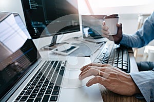 Programmer working On Computer In IT Office Typing Data Coding in software and checking code on computer screen