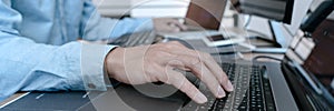 Programmer working On Computer In IT Office Typing Data Coding in software and checking code on computer screen