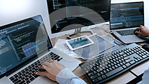 Programmer working On Computer In IT Office Typing Data Coding in software and checking code on computer screen