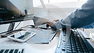 Programmer working On Computer In IT Office Typing Data Coding in software and checking code on computer screen