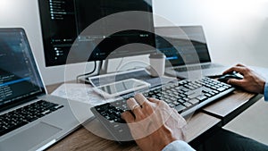Programmer working On Computer In IT Office Typing Data Coding in software and checking code on computer screen
