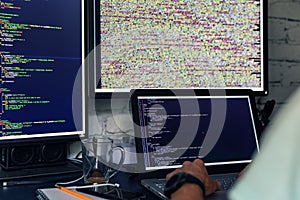 Programmer working on multiple computers