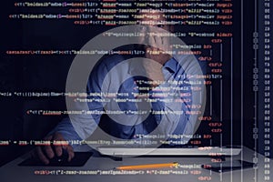 programmer working with programming code on computer screen