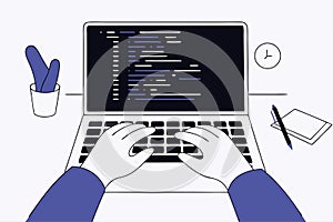 Programmer writes code on a laptop. Software development