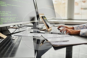 Programmer writing code connecting with smartphone