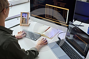 Programmer writing security codes on computer