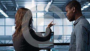 Programmers coding on laptop using artificial intelligence in server farm